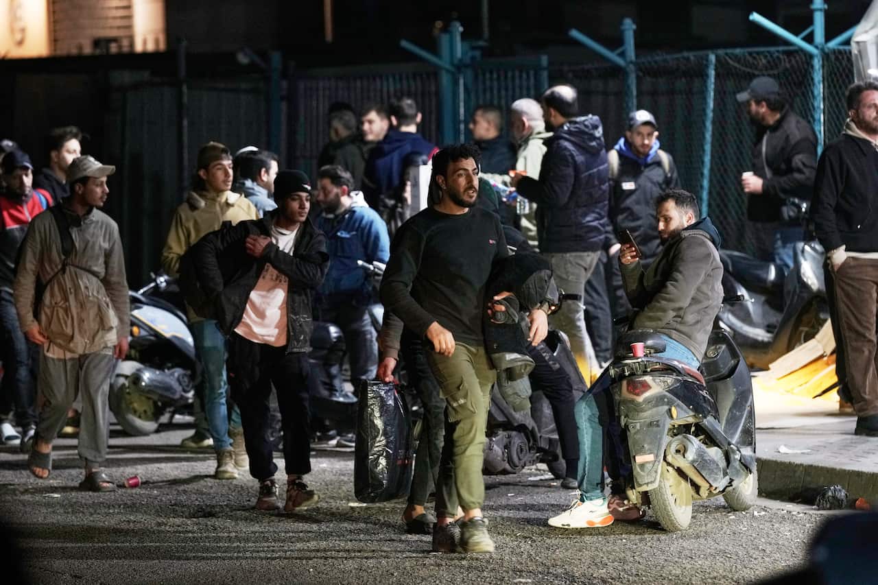 A group of people walking along a road.