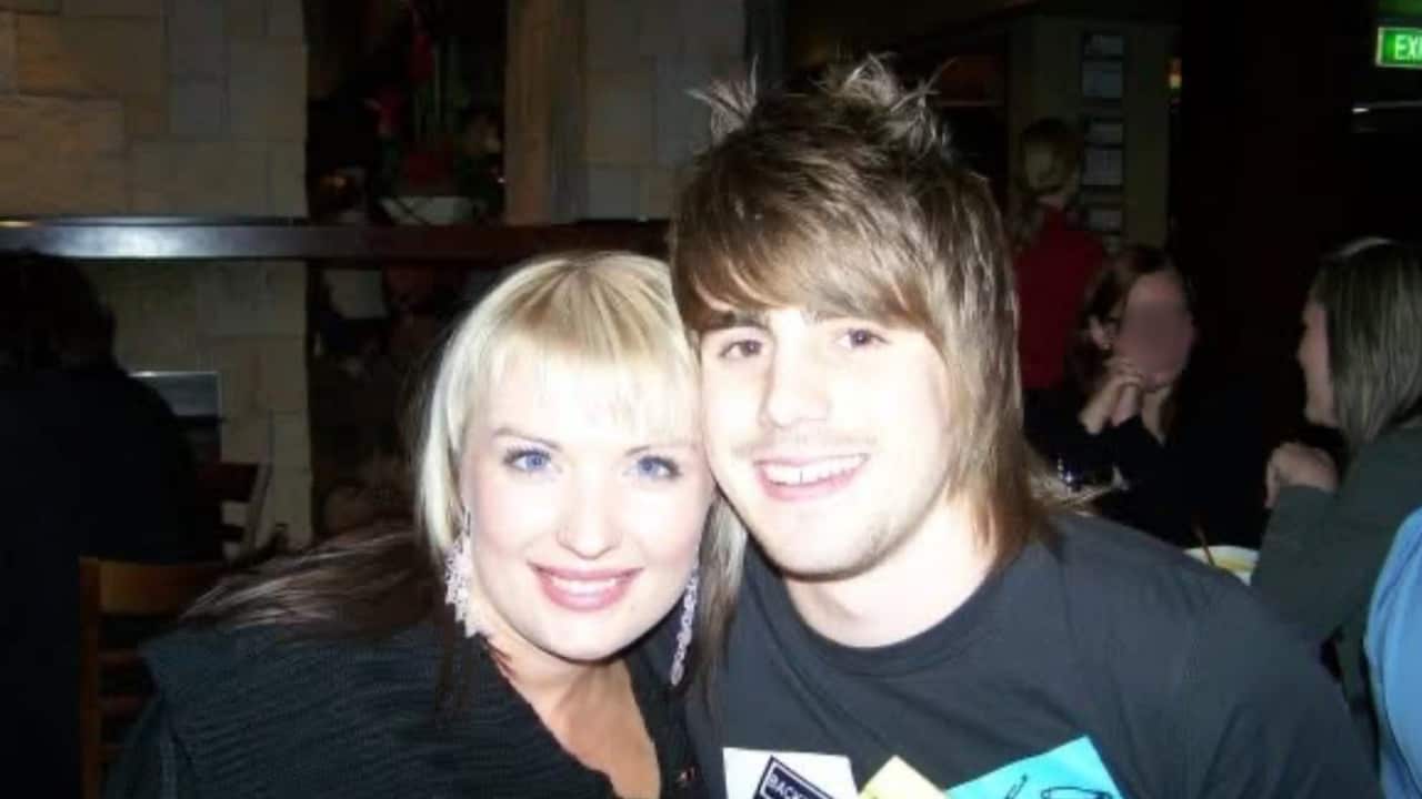 a digital camera shot of a young blonde woman and a brownhaired man with spiky hair in a nightclub