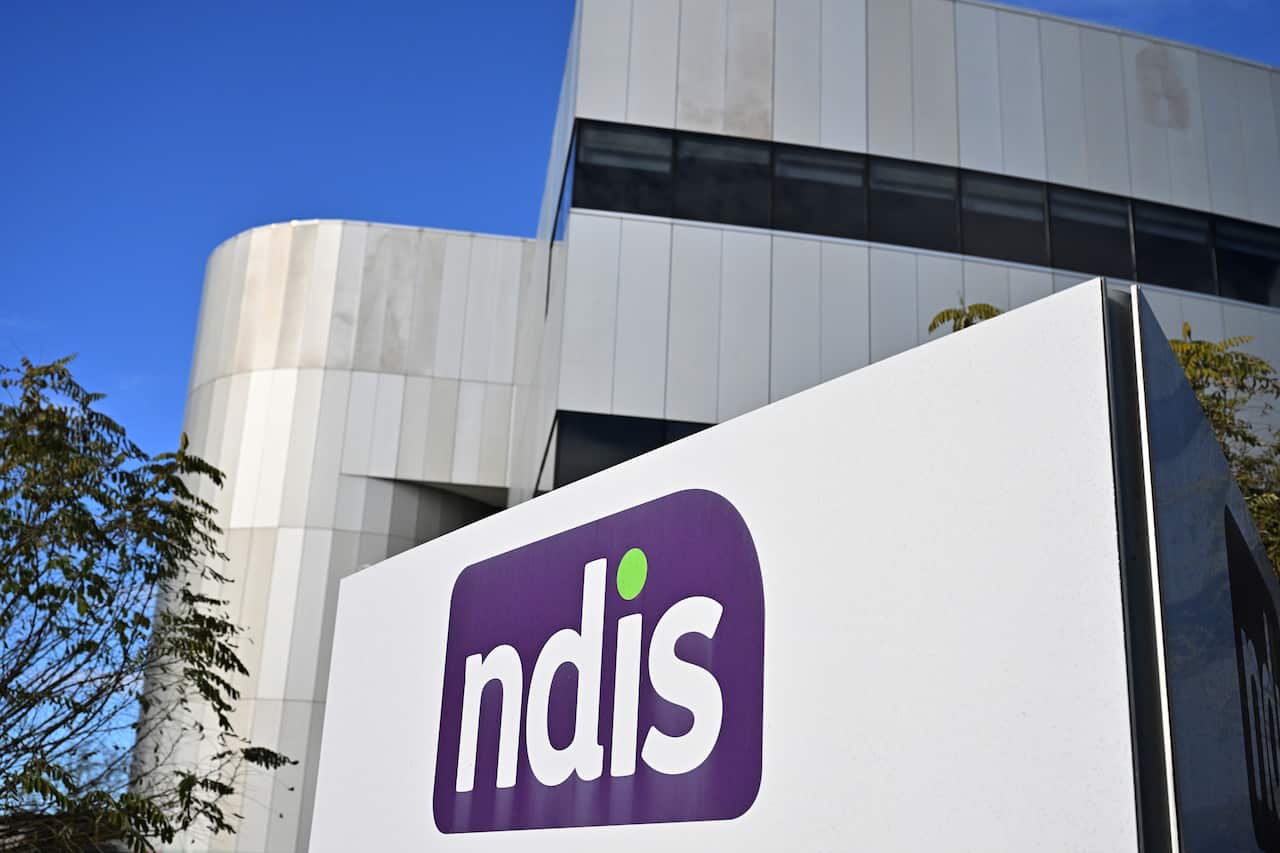 Outdoor shot of the National Disability Insurance Scheme head office with the NDIS  logo on the side of the building.