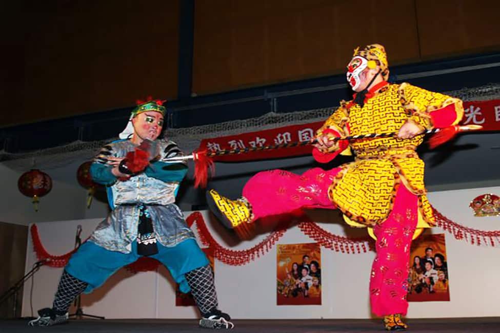 Two people in traditional costume performing a dance