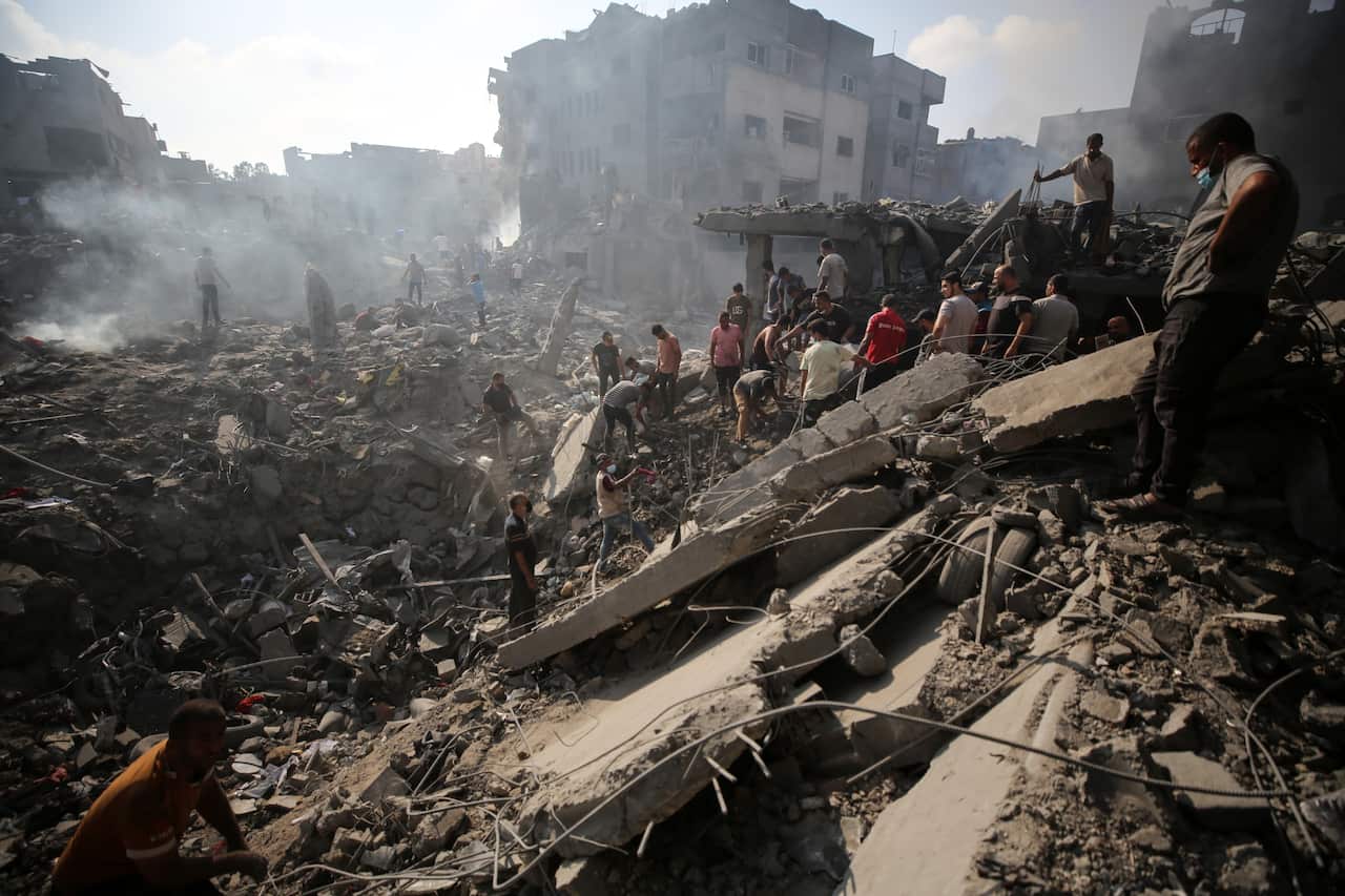 People standing on top of rubble.