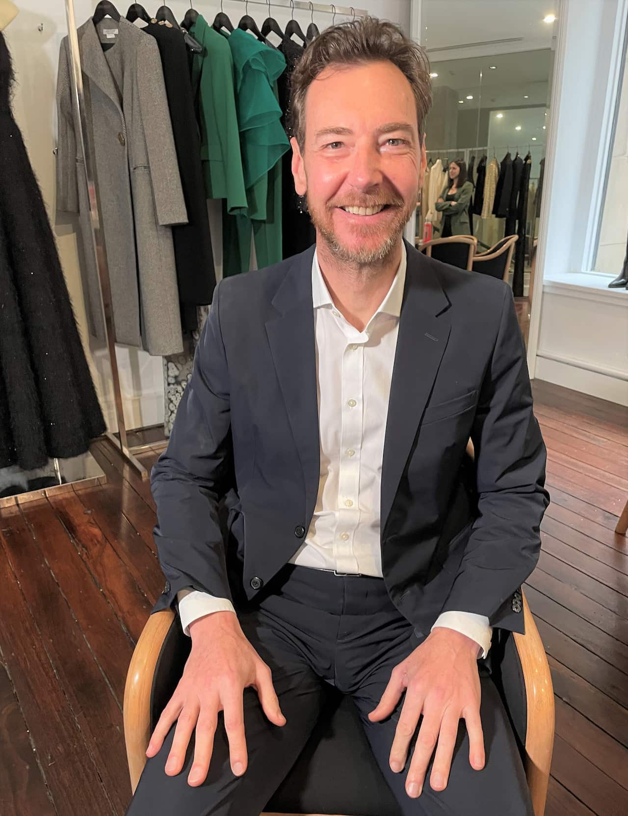 A man wearing a suit sitting in a chair