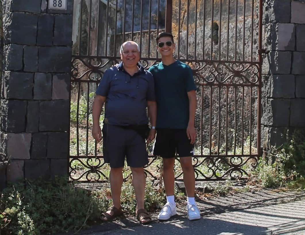 John Samperi in front of the gate of his ancestral home in Italy in 2022.