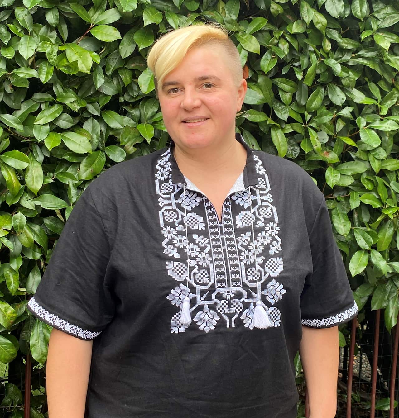 Marianna Polevikova in front of a hedge Australia.