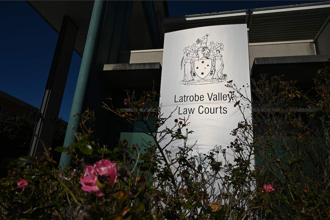 A court sign with flowers in the foreground.