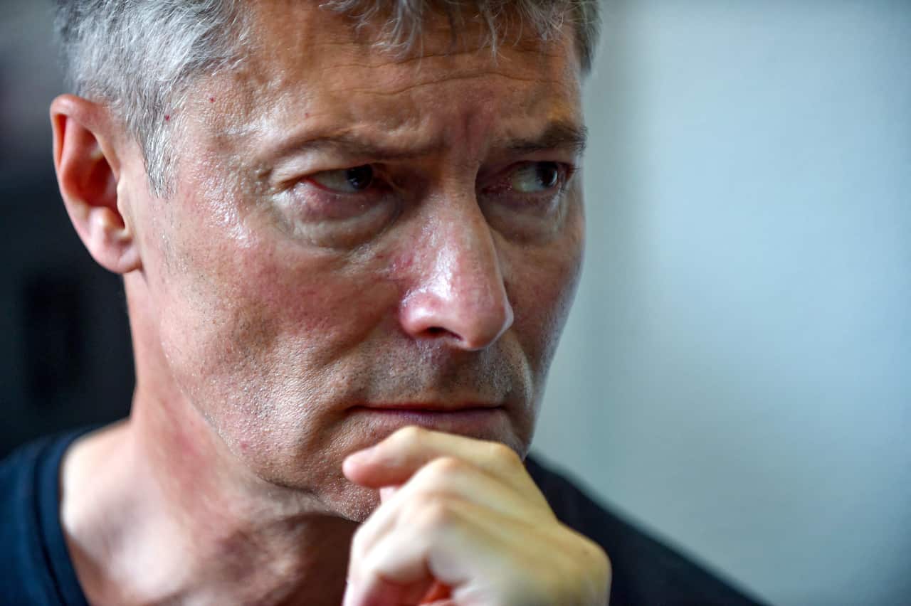 Yevgeny Roizman posing with his chin resting on his hand