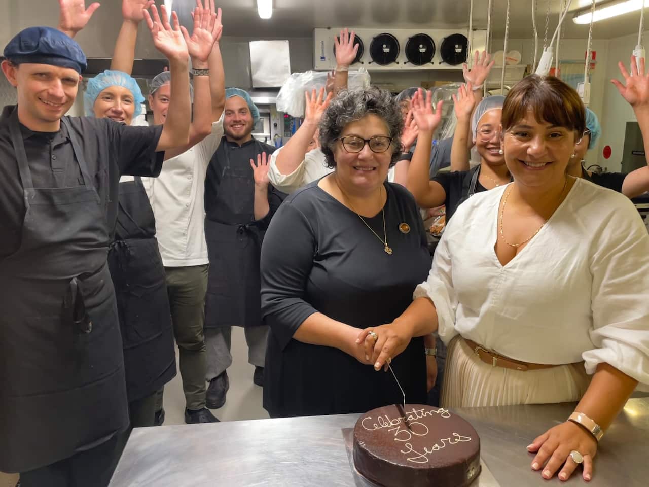 Adora founders and staff cut a cake to celebrate 30 years in business this week.