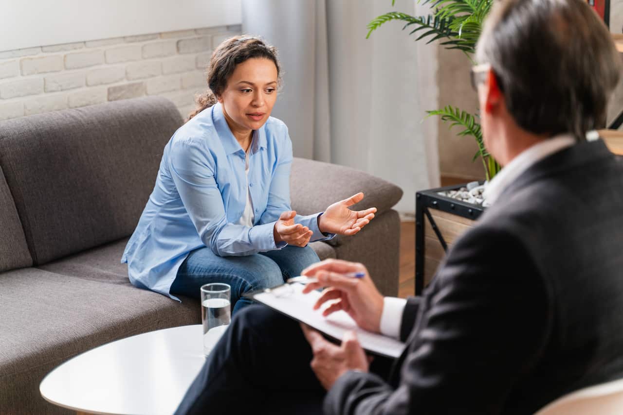Young woman talking to colleague at home
