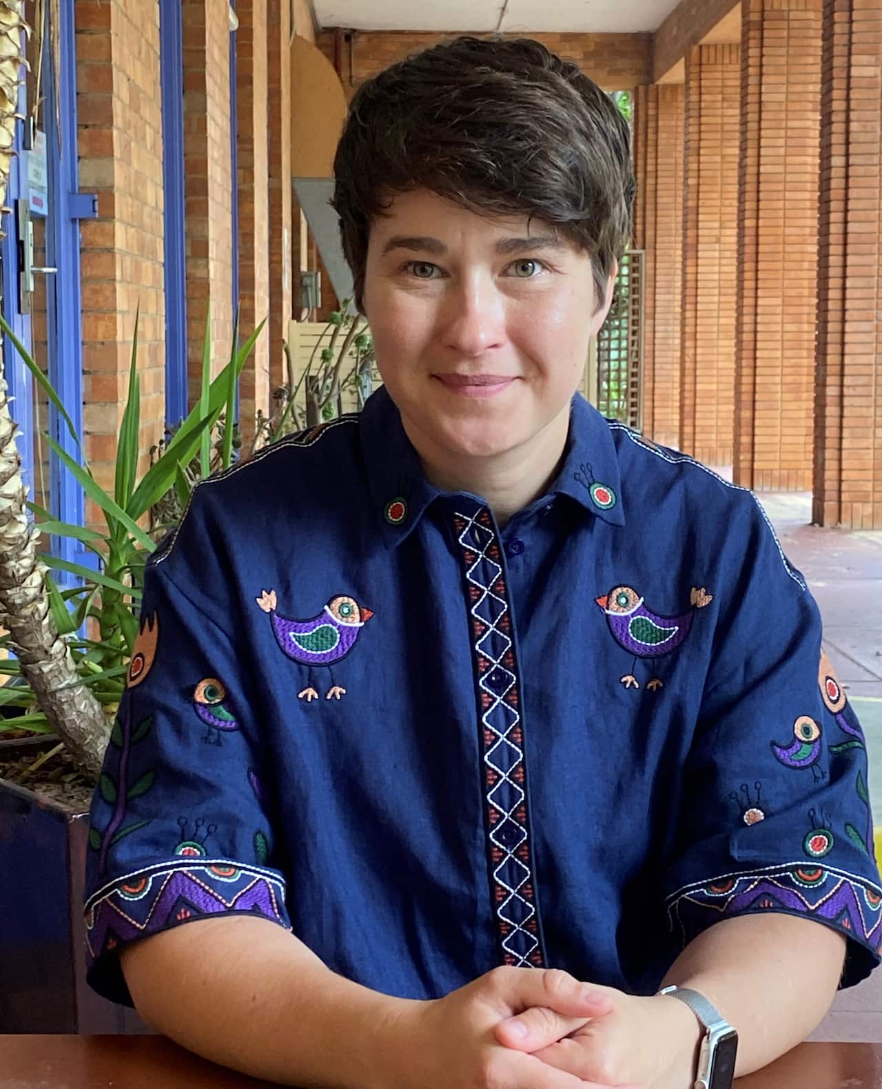 Renee Dixson sitting in a corridor in Canberra.