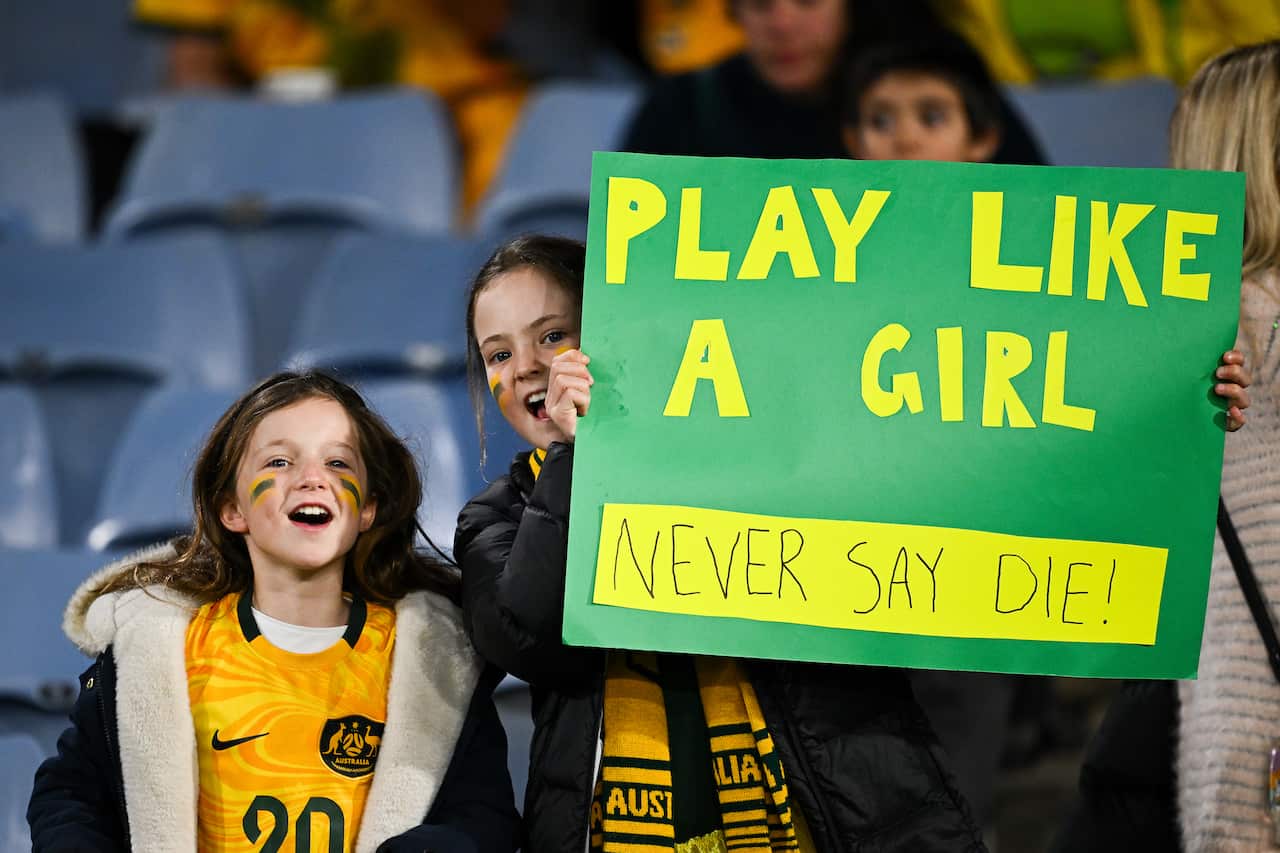 A group of Matildas players celebrate a goal.