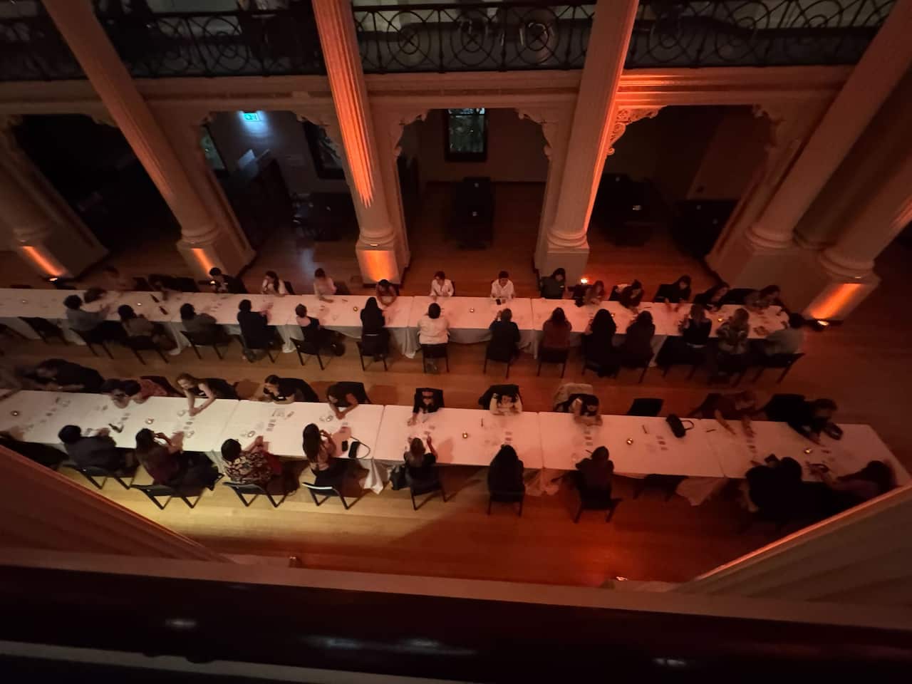 An aerial shot of speed dating at a long table. 