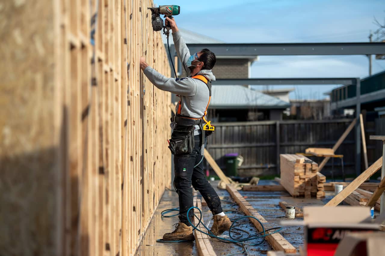 Construction worker on-site using a tool.