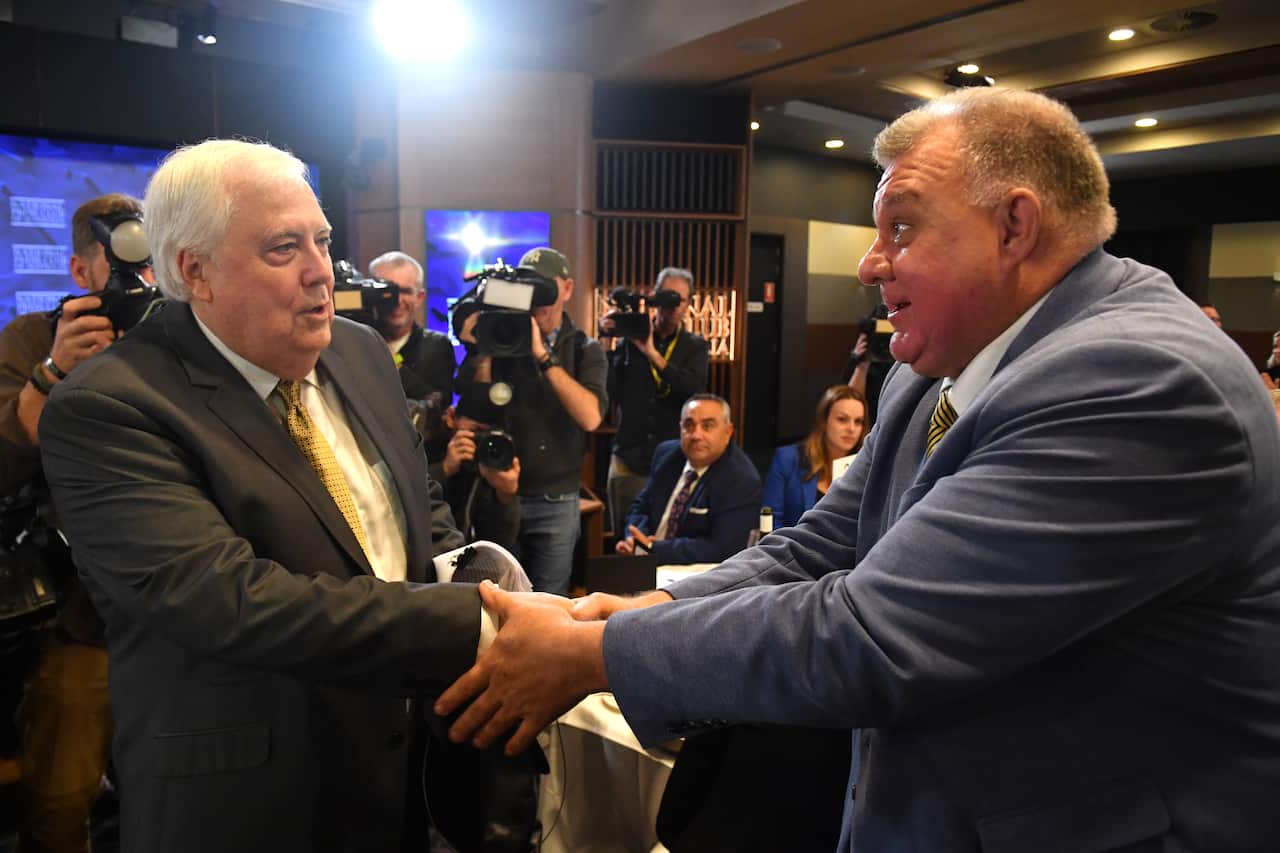 CLIVE PALMER shakes hands with Craig Kelly