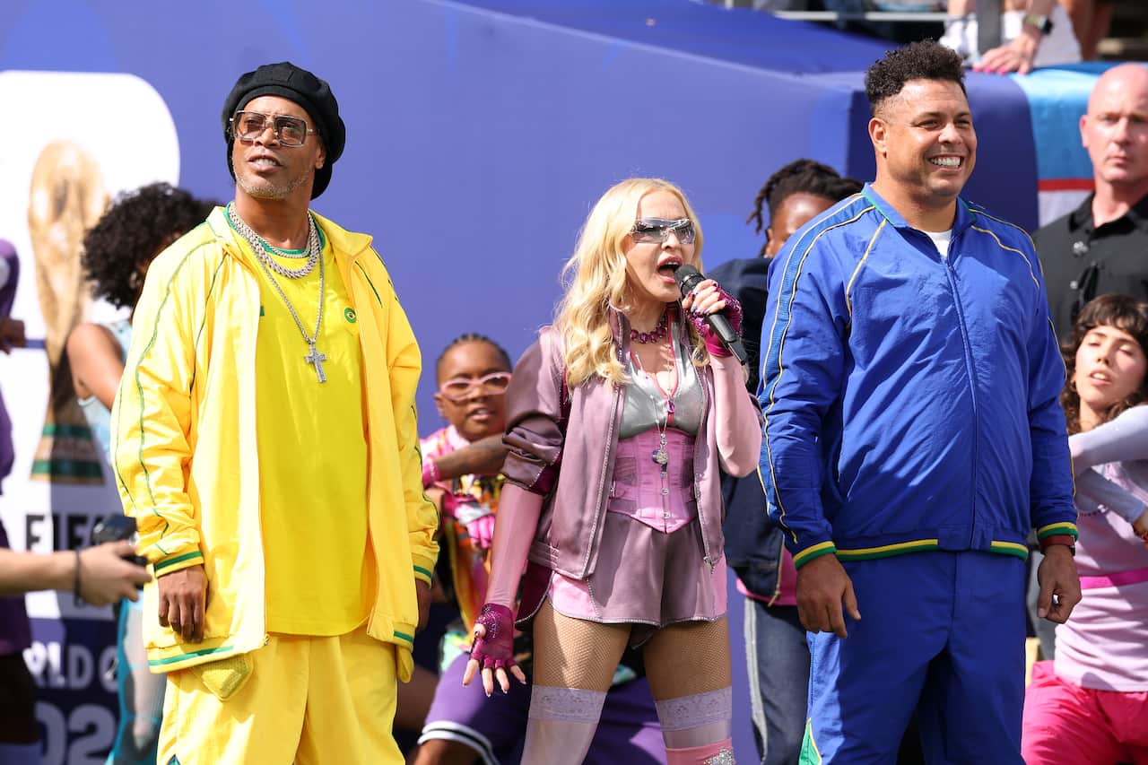 Madonna performs at the World Cup 2026 final half time show, flanked by ex players Ronaldo and Ronaldinho.