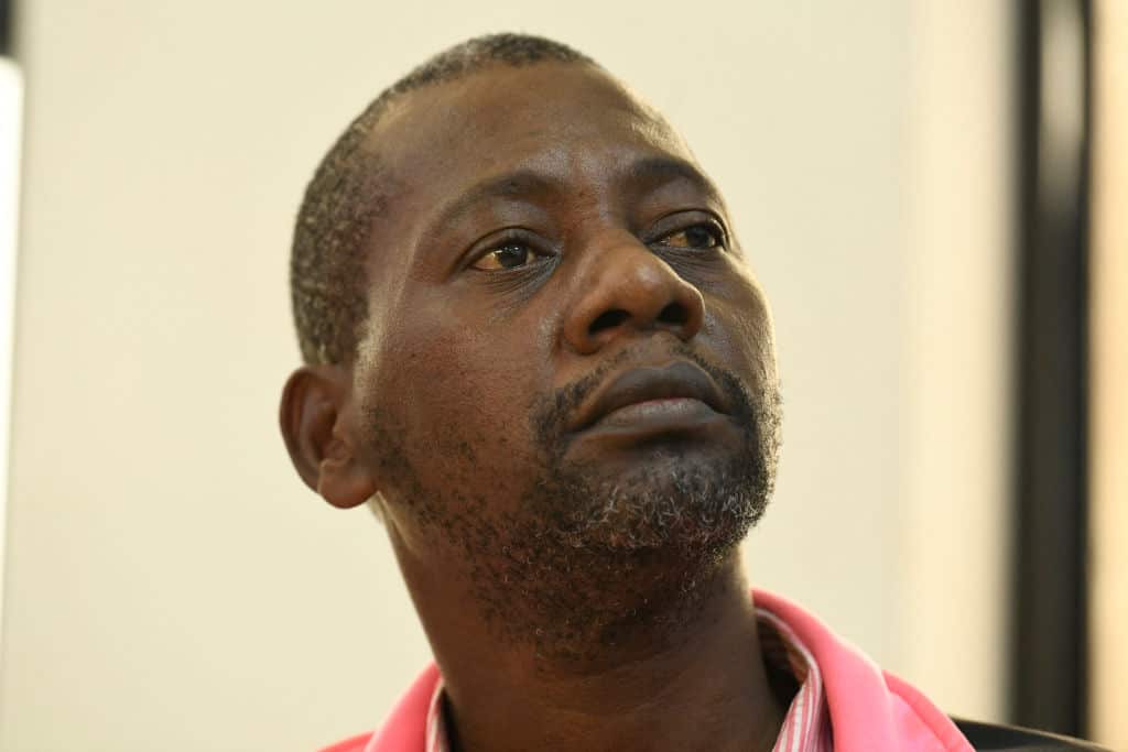 A portrait of a man with a serious expression.