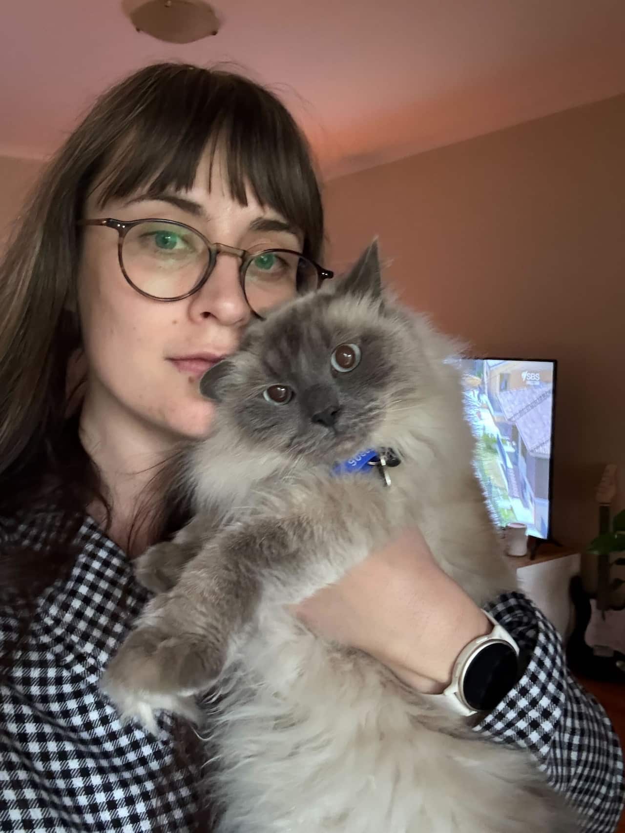 A girl posing with her cat.