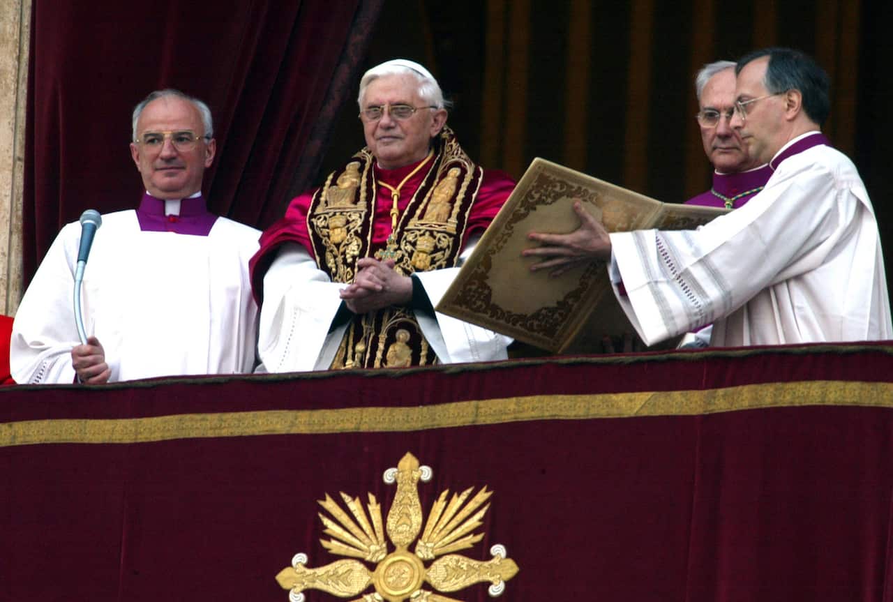 Pope Benedict XVI stands at the balcony greeting his audience in Rome.  