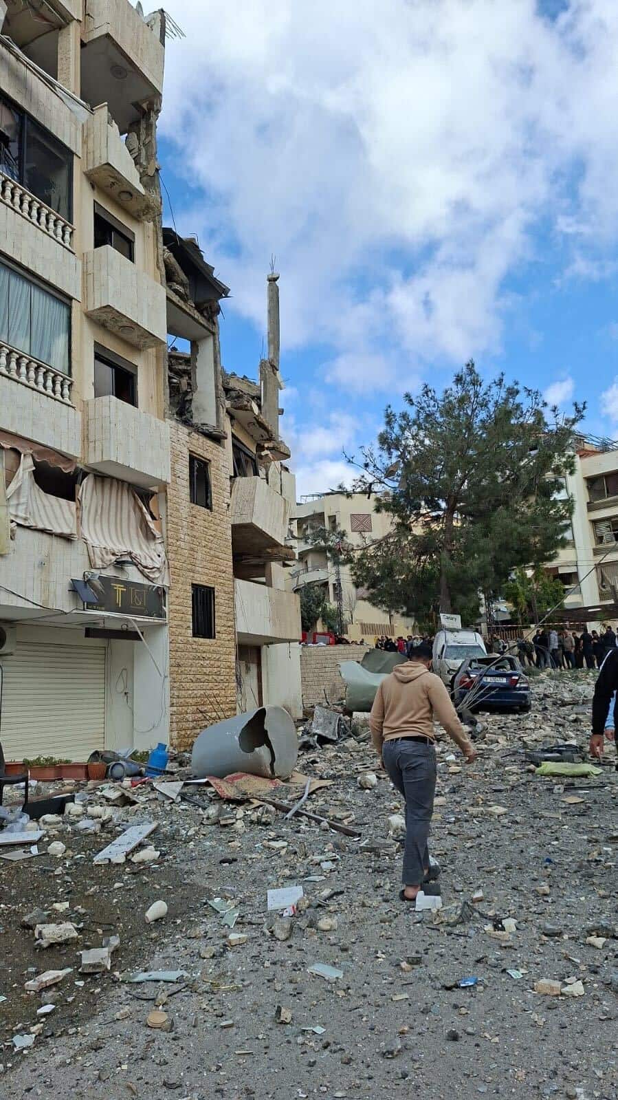 A building in the street with rubble surrounding it.