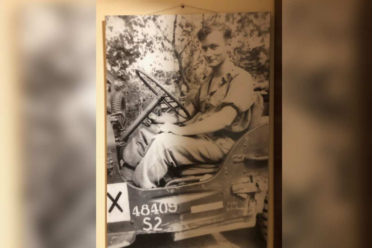 An old black-and-white picture of Colin Wagener sitting in a jeep during World War Two.