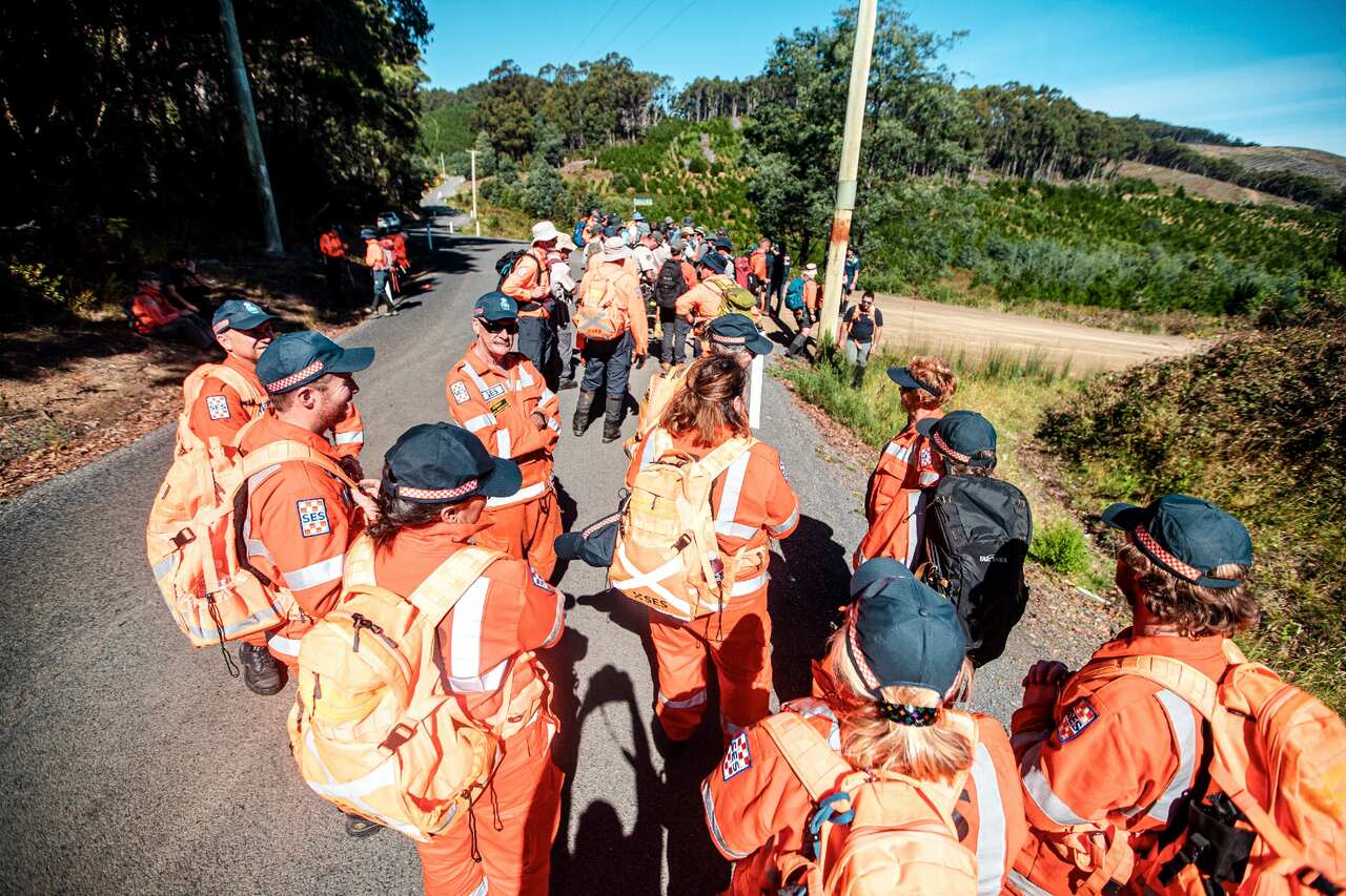 Emergency service workers are briefed by officials as the search effort gets underway. 