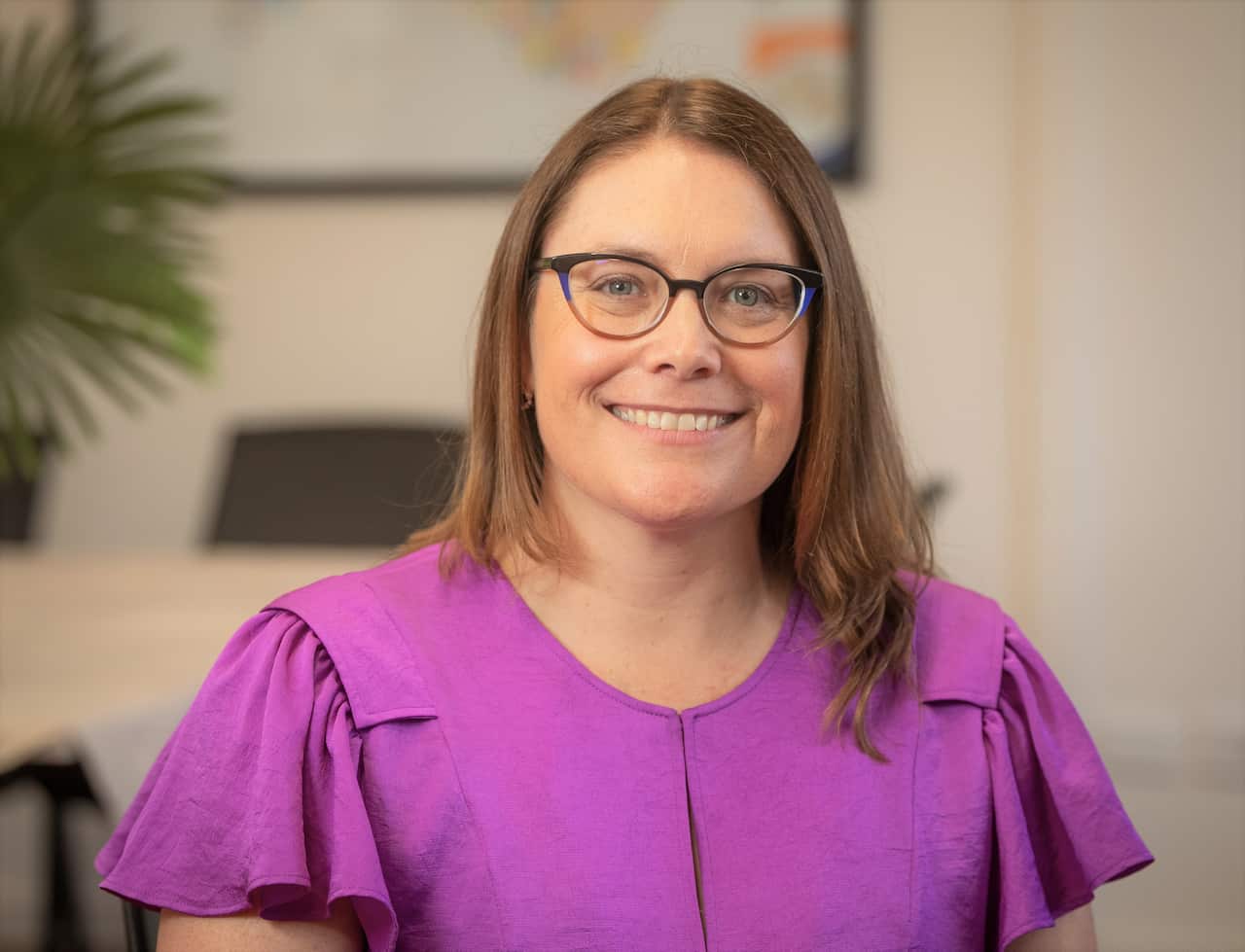 A woman in a purple top.