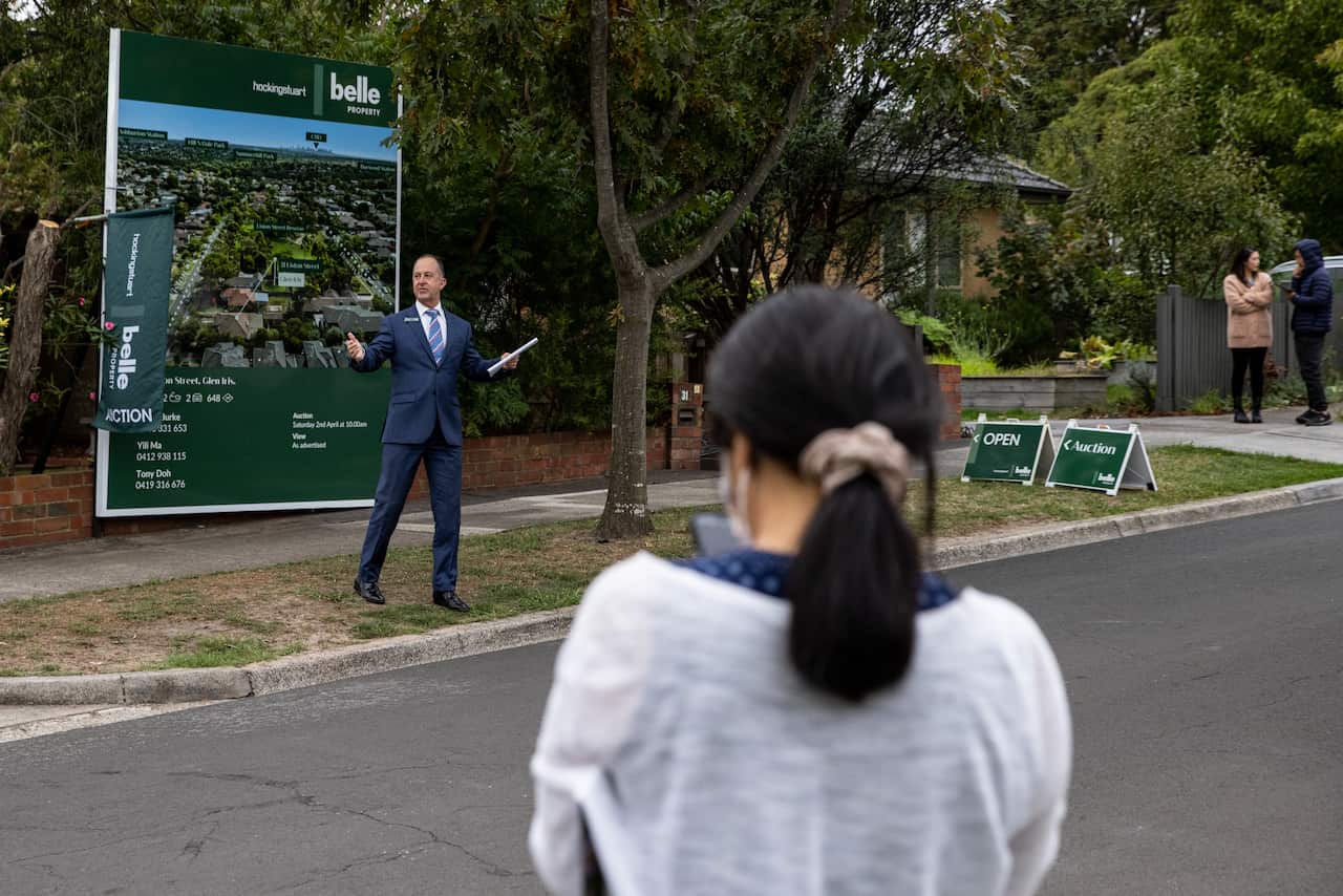 People watching a property auctioneer.