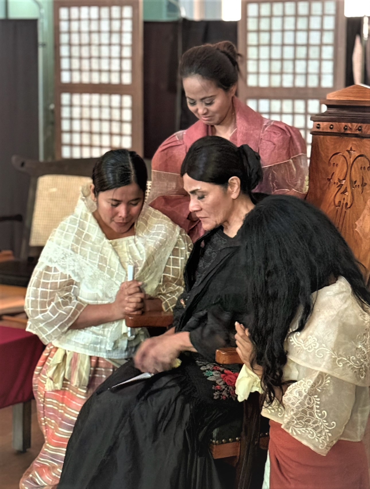 Actors Jinky Trijo-Marsh (standing), Grazie Panlican (left) and Aubrey Abanico (right) acted as Jose Rizal's sisters and Marilyn Mendez (seated) as Rizal's mother at the 'Parting at Calamba' stage play in December 2024.