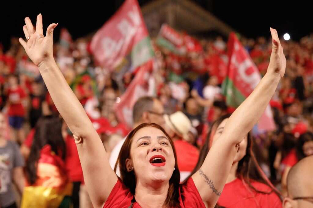 A woman cheering with her arms in the air.