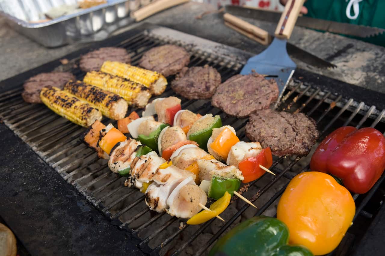 Burgers and Kebabs on a barbecue grill.