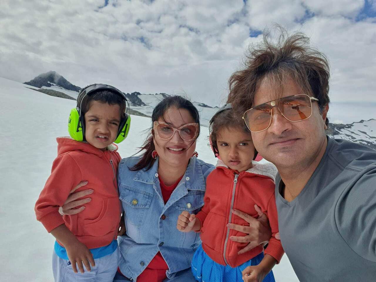A family wearing winter clothing on a mountain