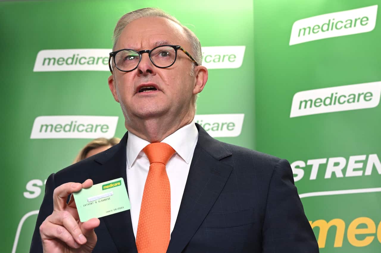 Man holding a small, green card.