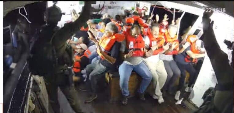 A group of people on a boat wearing life jackets