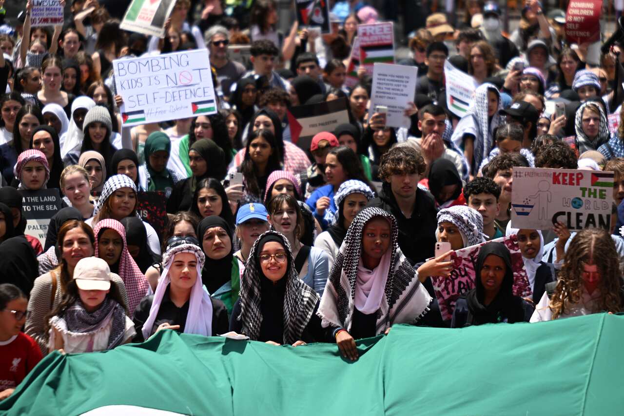Young people at a protest, carrying placards