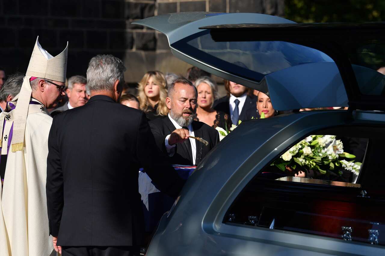 Andrew Landeryou, the husband of late Senator Kimberley Kitching, as pallbearers carry the casket during the funeral service for Senator Kimberley Kitching at St Patrick's Cathedral in Melbourne.