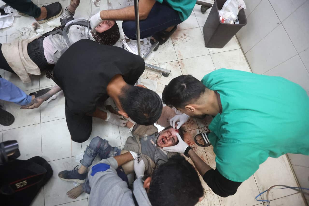 A young boy screams while being treated for wounds on the floor of a hospital in Khan Younis, Gaza.