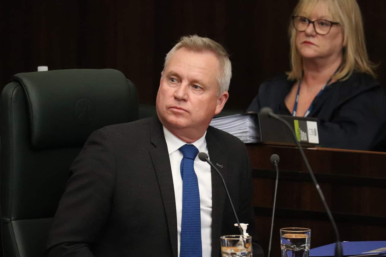 Tasmanian Premier Jeremy Rockliff seated in front of a microphone.