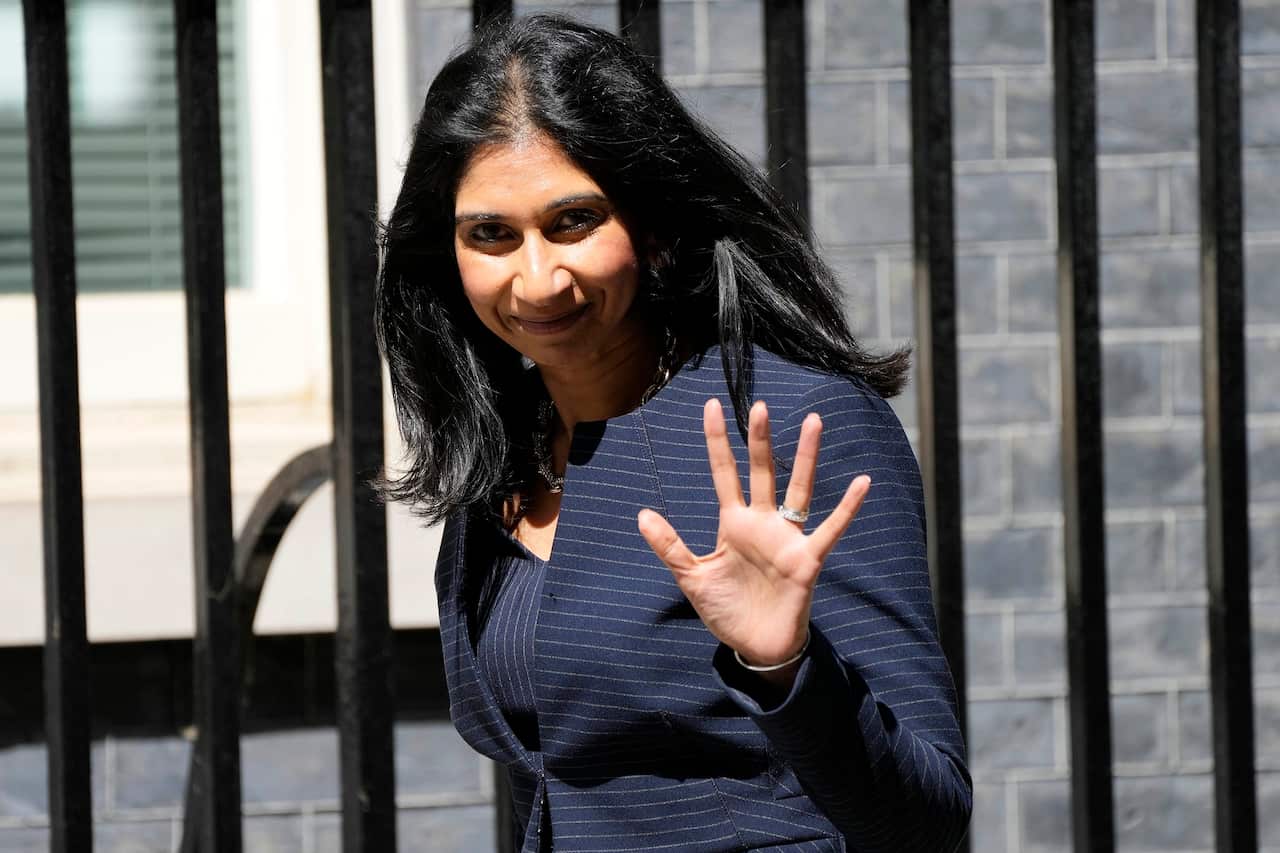 Suella Braverman waves to the camera.
