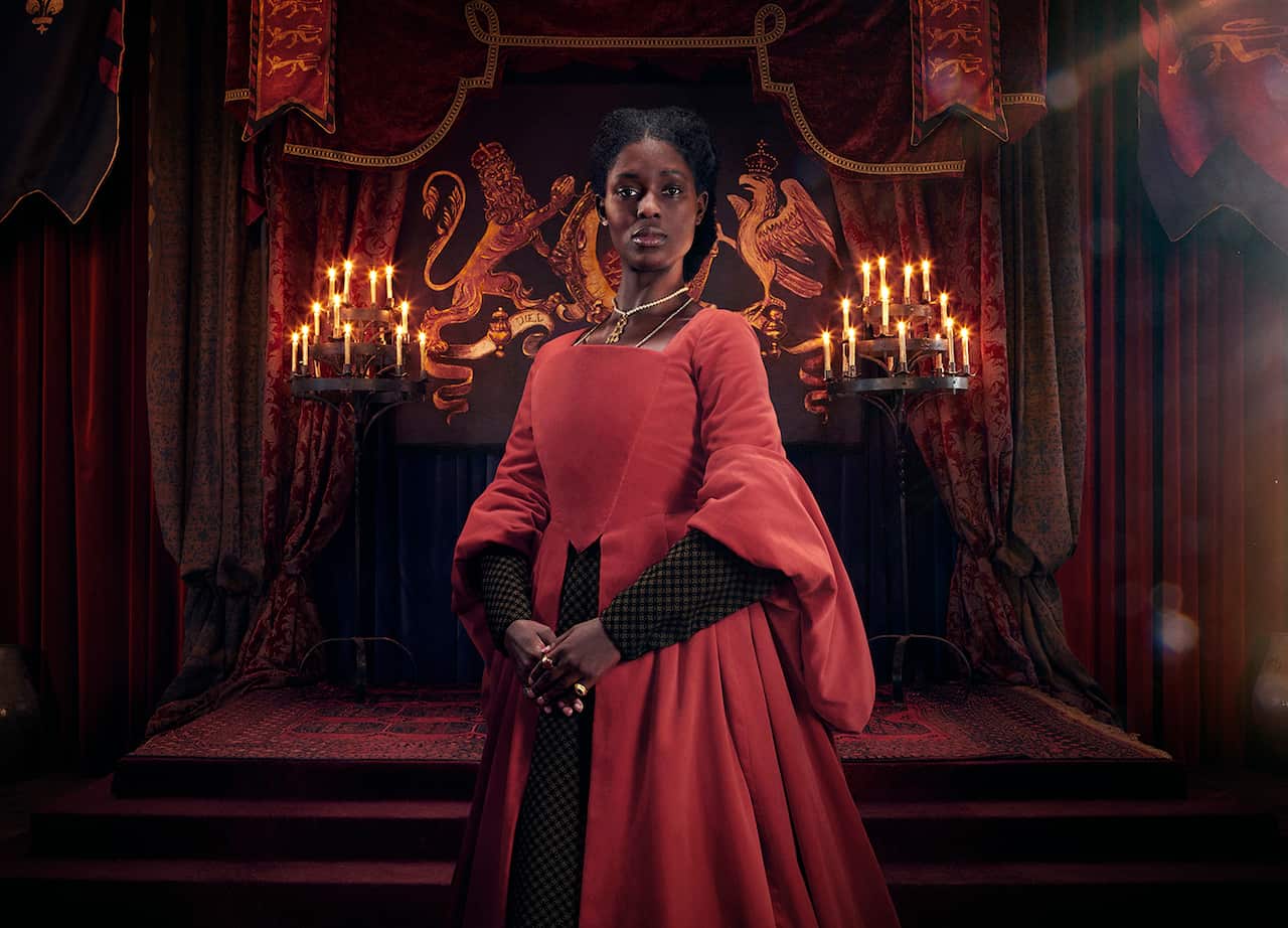 Actor Jodie Turner-Smith standing wearing a structured red gown as Anne Boleyn in miniseries Anne Boleyn.jpg