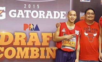 A basketball player in a red jersey gestures as he poses with another man wearing a red t-shirt.