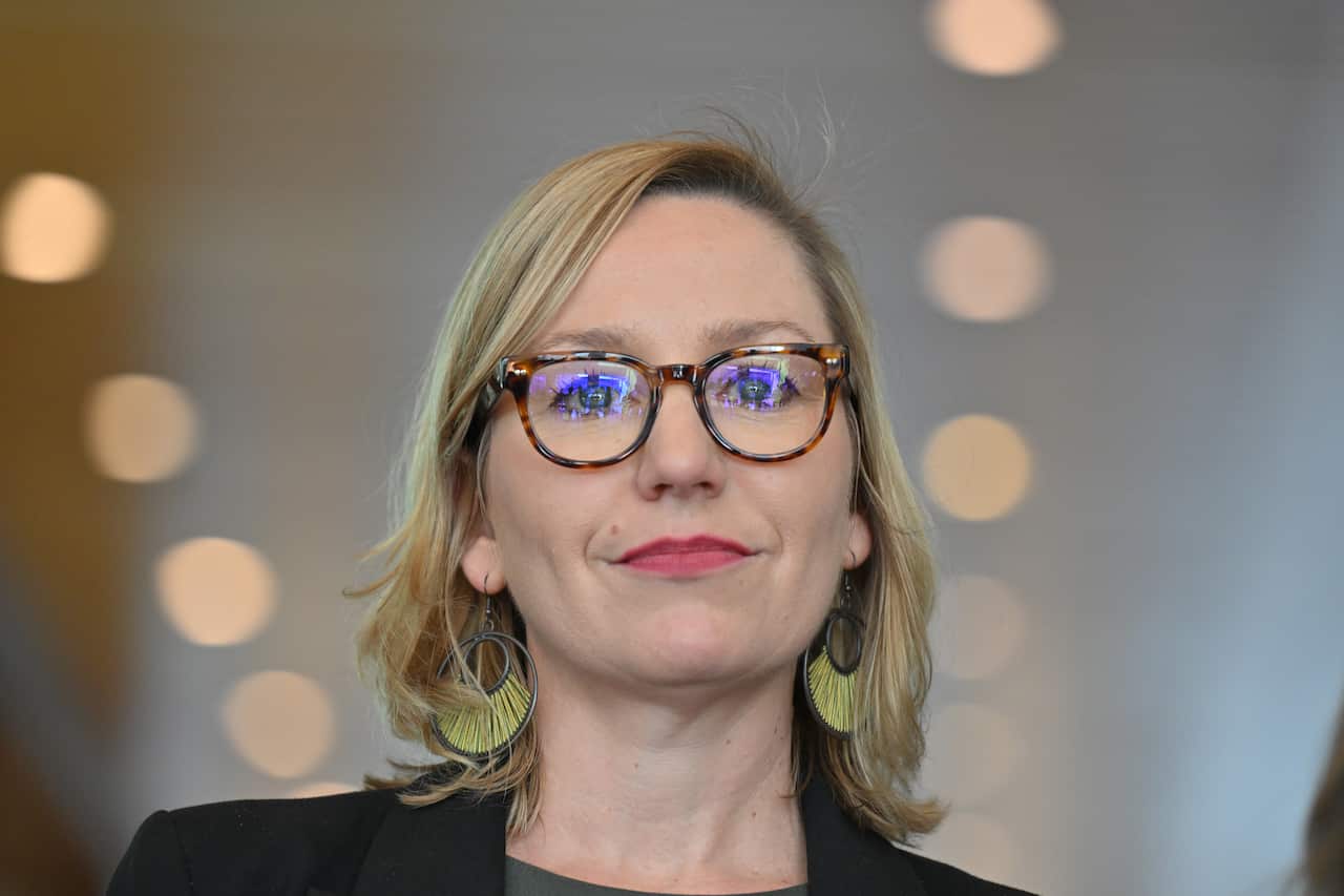 A blonde woman wearing glasses.