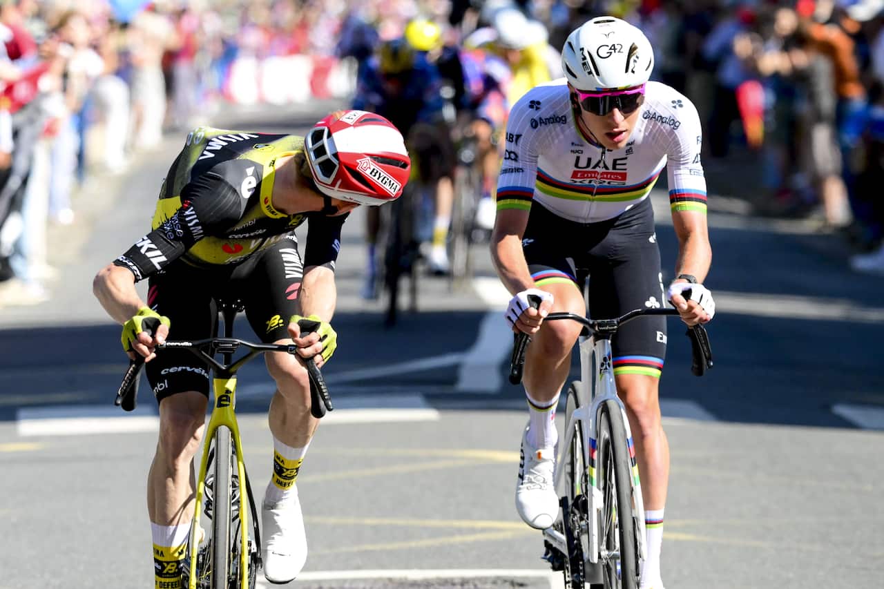 Two cyclists racing on bicycles.