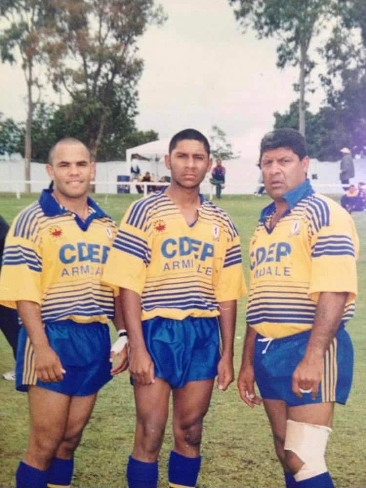 Three men in blue and gold Narwan uniform standing together