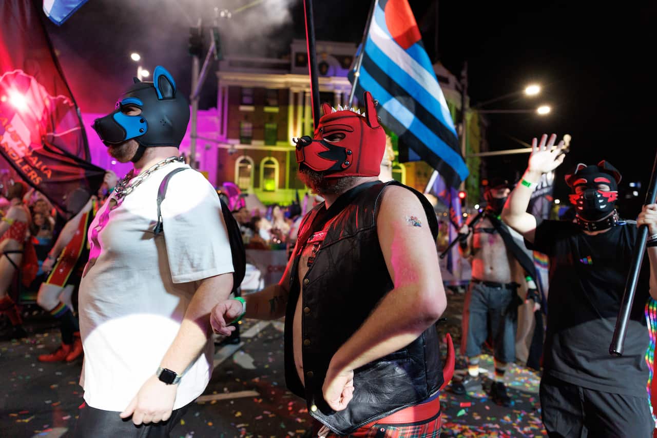Two men in dog masks walk at the Sydney Mardi Gras parade