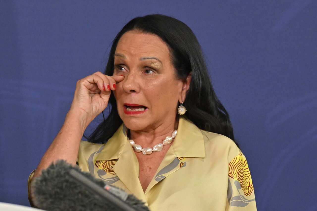 Linda Burney wipes away a tear while speaking at a press conference.