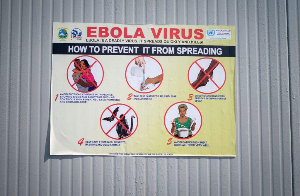 A sign on the premises of a healthcare facility points out symptoms, danger of infection and course of Ebola.