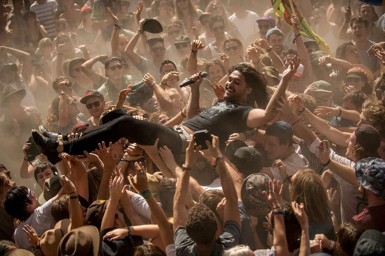 A singer crowd surfing at a festival