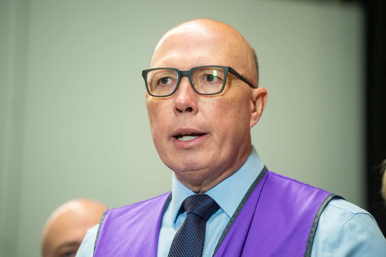 Man in glasses in a hi-viz vest.