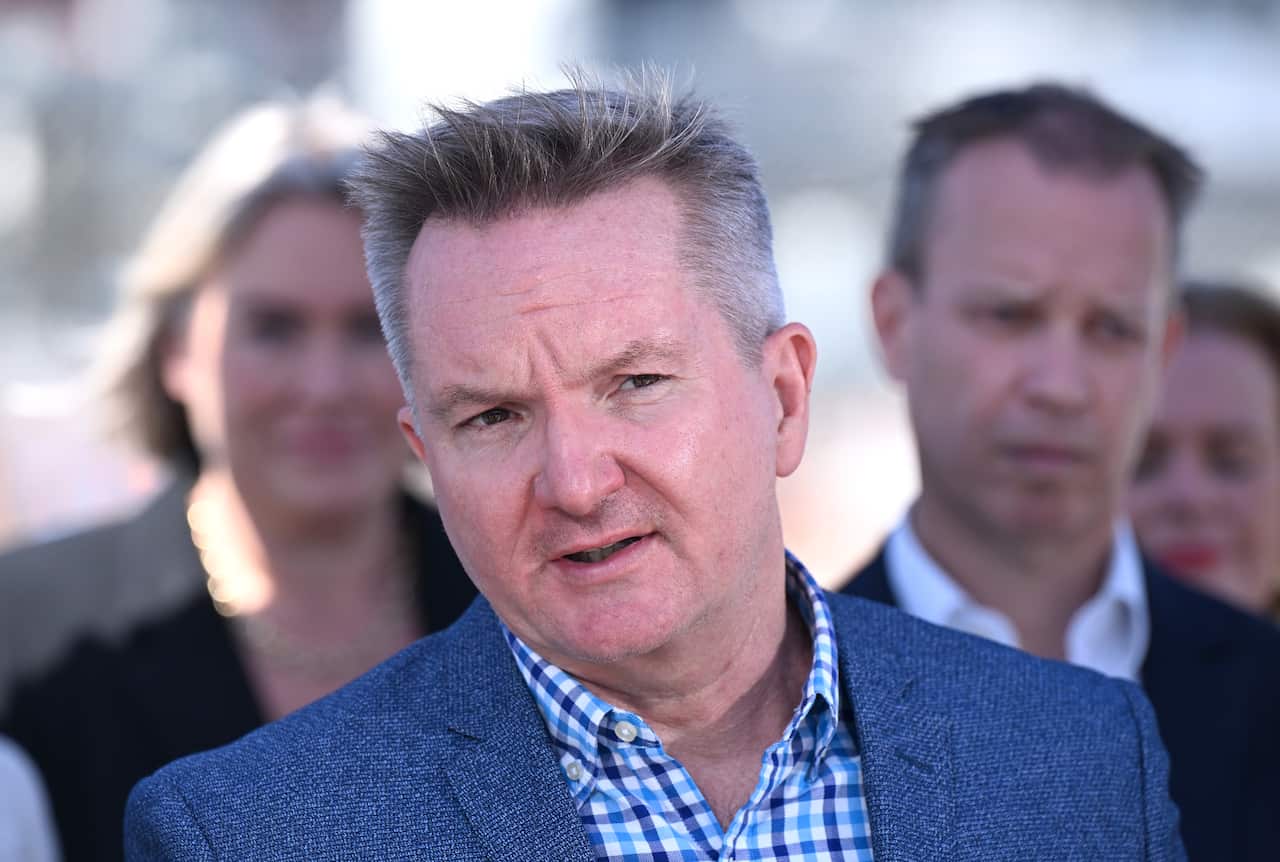 A man in a suit addressing reporters