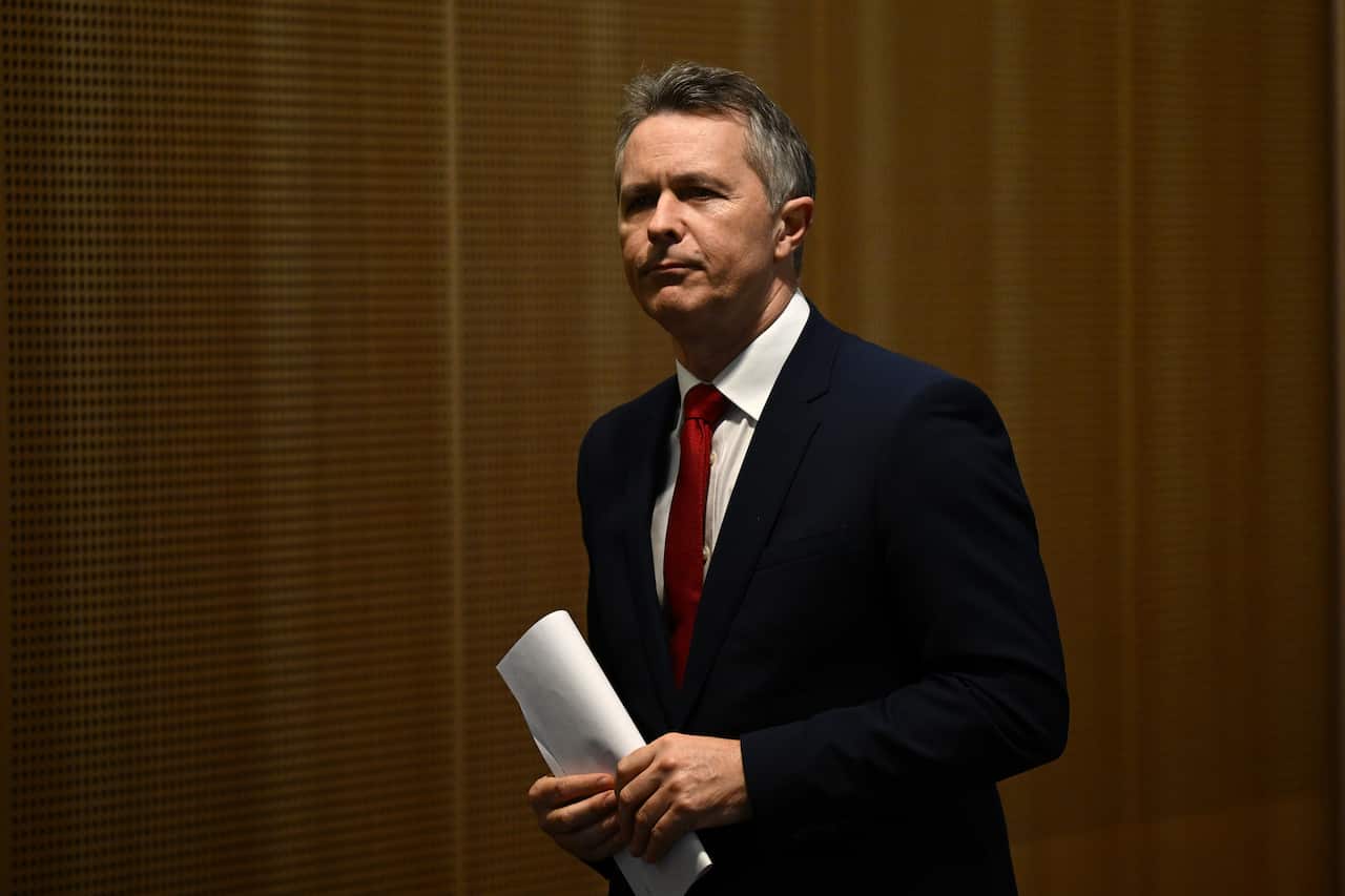 Man holding a sheet of paper in both hands.