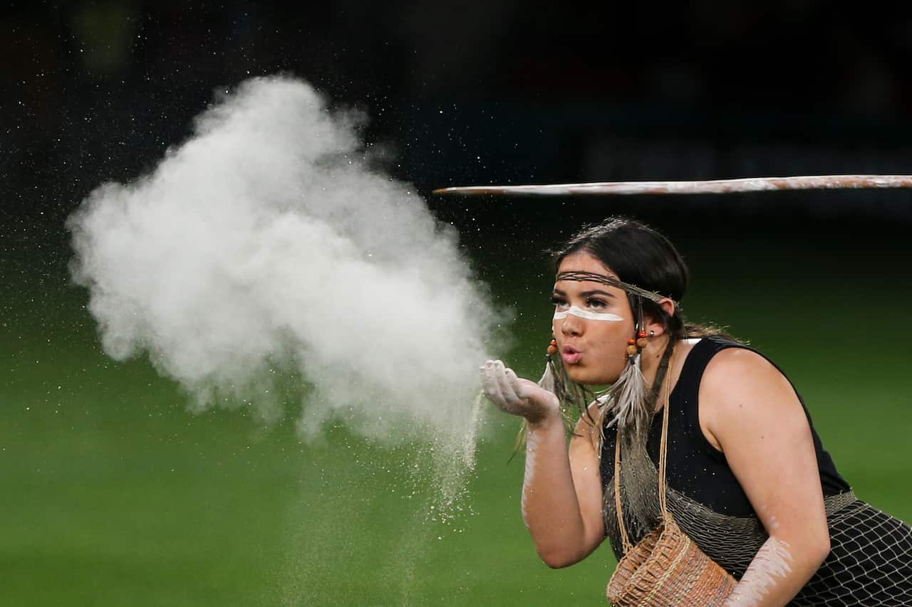 An Indigenous woman performs during a welcome to country ceremony.